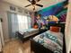 Twin beds sit beneath a turtle mural, complemented by a ceiling fan and tile floors at 2787 Oakwater Dr # 149, Kissimmee, FL 34747