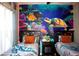 Fun-themed bedroom featuring twin beds, a ceiling fan, and an eye-catching ocean mural at 2787 Oakwater Dr # 149, Kissimmee, FL 34747