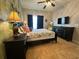 Comfortable bedroom featuring tiled floors, a ceiling fan, and natural light at 2787 Oakwater Dr # 149, Kissimmee, FL 34747