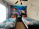 Themed bedroom featuring twin beds, a ceiling fan, and unique ocean mural at 2787 Oakwater Dr # 149, Kissimmee, FL 34747