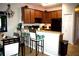 Dining room features table, chairs, lighting fixture, with kitchen in the background at 2787 Oakwater Dr # 149, Kissimmee, FL 34747