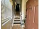 Charming entryway with a tiled floor and carpeted stairs leading to the upper level at 2787 Oakwater Dr # 149, Kissimmee, FL 34747