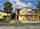 Inviting two-story townhome features a private screened balcony and attached garages at 2787 Oakwater Dr # 149, Kissimmee, FL 34747