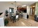The kitchen features wood cabinets, black appliances, neutral countertops and tiled floor next to dining room at 2787 Oakwater Dr # 149, Kissimmee, FL 34747