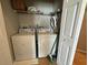 A functional laundry room featuring a white washer and dryer, ensuring convenient chore management at 2787 Oakwater Dr # 149, Kissimmee, FL 34747