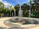 Community splash pad surrounded by palm trees providing a refreshing, fun filled area for residents at 2787 Oakwater Dr # 149, Kissimmee, FL 34747