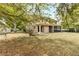 Private backyard with mature trees, providing shade and enhancing the outdoor living experience at 30439 Gidran Ter, Mount Dora, FL 32757