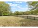Sprawling backyard with black wood perimeter fence offering privacy and space for outdoor enjoyment at 30439 Gidran Ter, Mount Dora, FL 32757