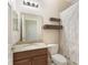 Bathroom with a granite vanity, floating shelves, and shower/tub with curtain at 30439 Gidran Ter, Mount Dora, FL 32757