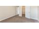 Bedroom featuring carpet, neutral walls, and open doorway to a walk-in closet at 30439 Gidran Ter, Mount Dora, FL 32757