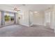 Open bonus room featuring neutral carpet, ceiling fan, and natural light from the windows at 30439 Gidran Ter, Mount Dora, FL 32757
