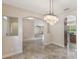 Dining room featuring tile flooring, a chandelier, and arched doorways leading to other rooms at 30439 Gidran Ter, Mount Dora, FL 32757