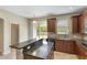 Kitchen featuring wood cabinets, granite countertops, and a view of the backyard at 30439 Gidran Ter, Mount Dora, FL 32757