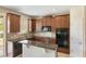Kitchen with dark wood cabinets, granite countertops, and stainless steel appliances at 30439 Gidran Ter, Mount Dora, FL 32757