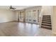 Living room with hardwood floors, a ceiling fan, and doors leading to the backyard at 30439 Gidran Ter, Mount Dora, FL 32757