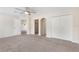 Spacious main bedroom featuring neutral carpet, walk-in closet and open doorway at 30439 Gidran Ter, Mount Dora, FL 32757