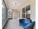 Screened-in porch featuring blue seating, concrete flooring and access to backyard at 30439 Gidran Ter, Mount Dora, FL 32757
