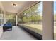 Screened-in porch with blue seating and view of the fenced backyard at 30439 Gidran Ter, Mount Dora, FL 32757