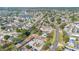 An aerial view highlights this community's layout, featuring communal areas, mature trees, a serene pond, and surrounding residences at 31 Las Palmas Way, Kissimmee, FL 34743