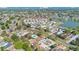 A wide aerial shot showcases the community with common pool and parking areas, mature trees, and a pond nearby at 31 Las Palmas Way, Kissimmee, FL 34743