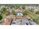 An aerial view showcases the community's layout with manicured lawns, mature trees, communal pool, and residential buildings at 31 Las Palmas Way, Kissimmee, FL 34743