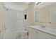 A clean bathroom features a tub and shower combination with marble-look tile surround and a vanity with a sink and a mirror at 31 Las Palmas Way, Kissimmee, FL 34743