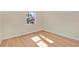 Comfortable bedroom featuring wood flooring, a window, and neutral walls at 31 Las Palmas Way, Kissimmee, FL 34743