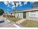 Street view of condo with tidy landscaping, neutral paint scheme, and available parking at 31 Las Palmas Way, Kissimmee, FL 34743