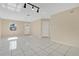 Inviting living room with tile floors, a front-facing window, and a modern lighting fixture at 31 Las Palmas Way, Kissimmee, FL 34743