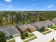 Aerial view of home featuring a screened pool, lush landscaping, and well-maintained yard at 310 N Hampton Dr, Davenport, FL 33897