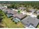 Beautiful aerial view of the property with a screened-in pool and lush green surroundings at 310 N Hampton Dr, Davenport, FL 33897