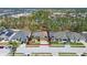 Aerial view featuring the home's layout, the screened-in pool, and the surrounding neighborhood with mature trees at 310 N Hampton Dr, Davenport, FL 33897