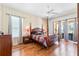 Bright bedroom boasts a wooden four-poster bed and hardwood floors at 310 N Hampton Dr, Davenport, FL 33897