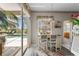 Bright dining area with breakfast bar, bar stools, and views of the pool and outdoor living at 310 N Hampton Dr, Davenport, FL 33897