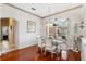 Tastefully decorated dining room with hardwood floors, a glass table, and elegant white chairs at 310 N Hampton Dr, Davenport, FL 33897