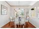 Formal dining room with hardwood floors, an elegant chandelier, and lots of natural light at 310 N Hampton Dr, Davenport, FL 33897