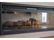 Close-up of electric fireplace with faux logs and ambient lighting at 310 N Hampton Dr, Davenport, FL 33897