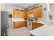 Bright kitchen featuring white countertops, wooden cabinetry, and modern appliances at 310 N Hampton Dr, Davenport, FL 33897
