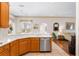 Well-lit kitchen with stainless steel appliances, white countertops, and tile flooring at 310 N Hampton Dr, Davenport, FL 33897