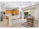 Open-concept kitchen with breakfast bar, wood cabinets, and sliding doors to the pool area at 310 N Hampton Dr, Davenport, FL 33897