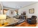 Cozy living room with hardwood floors, plush seating, and a fireplace entertainment center at 310 N Hampton Dr, Davenport, FL 33897