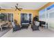 Inviting covered patio with stylish seating, ceiling fan, and sliding glass doors at 310 N Hampton Dr, Davenport, FL 33897
