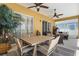 Covered patio featuring a dining table, seating area, ceiling fans and sliding glass doors at 310 N Hampton Dr, Davenport, FL 33897