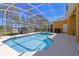 Inviting screened-in pool area with comfortable seating and a serene outdoor space perfect for relaxation and entertaining at 310 N Hampton Dr, Davenport, FL 33897