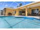 Screened pool area with covered patio and an inviting blue swimming pool at 310 N Hampton Dr, Davenport, FL 33897