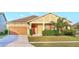 Charming single-story home with a manicured lawn and a attached two-car garage at 3131 Bass Boat Way, Kissimmee, FL 34746