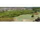 Aerial shot of golf course with a lake in the background surrounded by beautiful homes at 3131 Bass Boat Way, Kissimmee, FL 34746