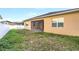 Fenced backyard with grass and an enclosed porch on the back of the house at 3131 Bass Boat Way, Kissimmee, FL 34746