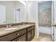 Bathroom featuring double vanity with granite countertop and tiled shower/tub combination at 3131 Bass Boat Way, Kissimmee, FL 34746