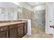 Bathroom featuring a double vanity, granite countertops, and a glass-enclosed shower at 3131 Bass Boat Way, Kissimmee, FL 34746